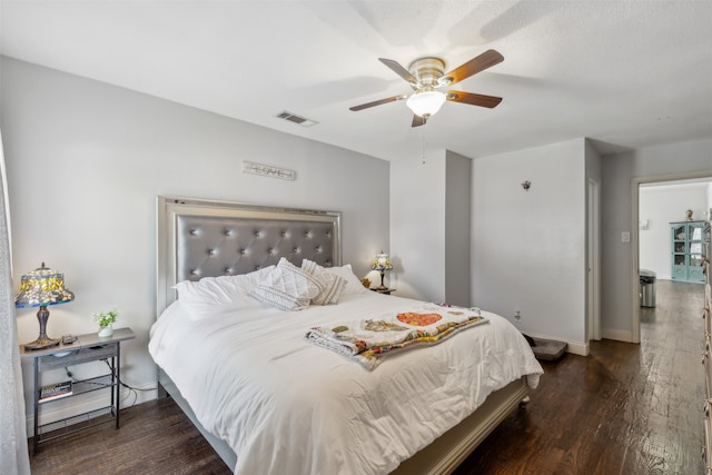 bedroom with ceiling fan and dark hardwood / wood-style floors