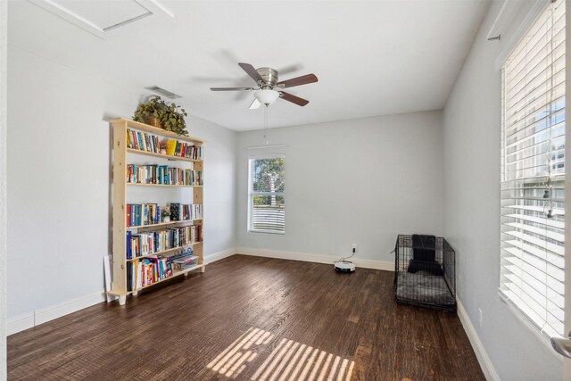 living area with dark hardwood / wood-style flooring and ceiling fan