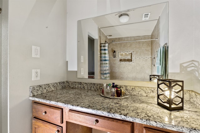 bathroom featuring a shower with curtain and vanity