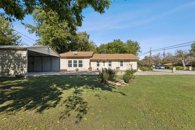 view of front of home with a carport and a front lawn