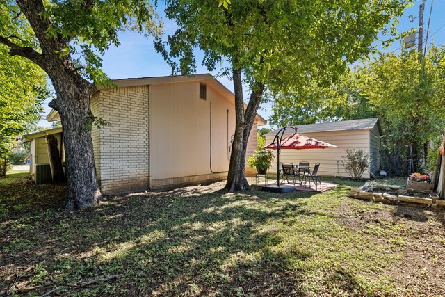 view of home's exterior with a patio and a yard