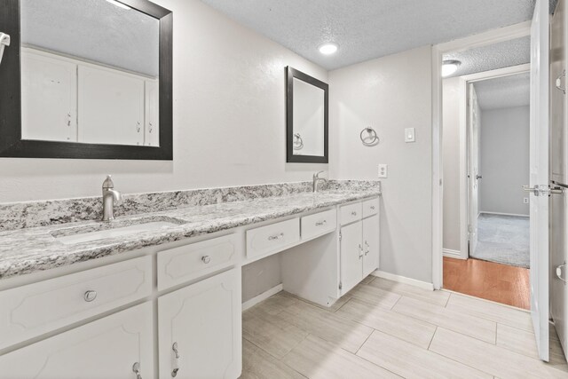 bathroom with vanity and a textured ceiling