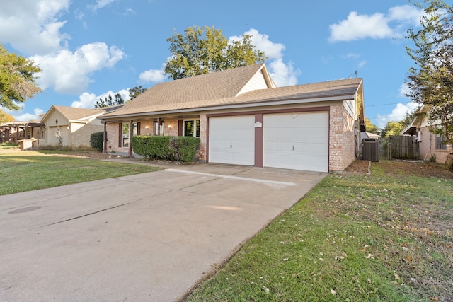 view of front of home featuring a garage, central AC unit, and a front lawn