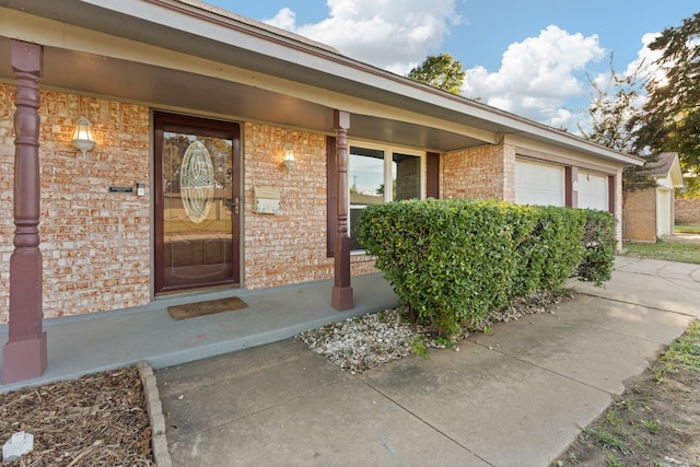 property entrance featuring a garage and covered porch