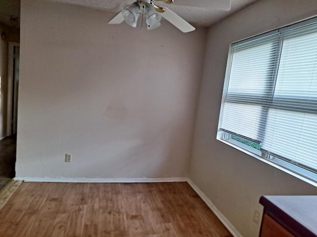 unfurnished room with hardwood / wood-style floors, ceiling fan, and a textured ceiling