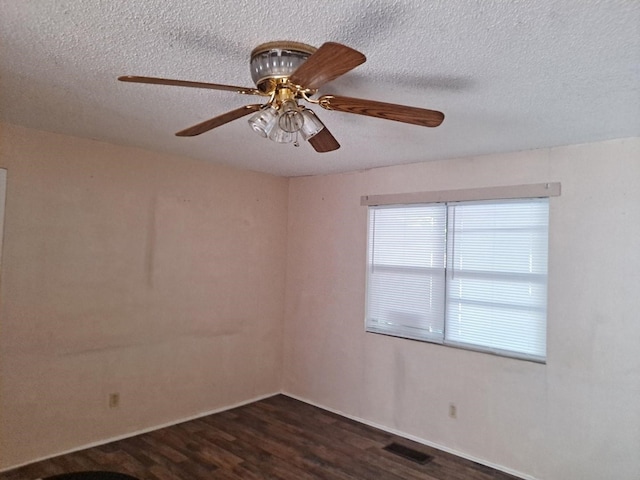 unfurnished room with dark hardwood / wood-style flooring, a textured ceiling, and ceiling fan