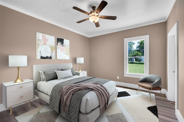 bedroom featuring ceiling fan, light wood-type flooring, and ornamental molding