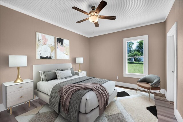 bedroom featuring ceiling fan, light wood-type flooring, and ornamental molding