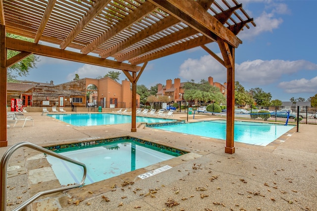 view of swimming pool with a hot tub, a patio, and a pergola