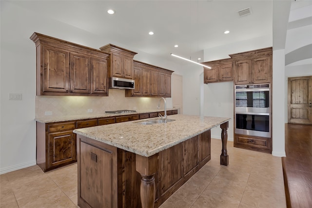 13647 Monstrell Rd, Frisco, TX 75035 - kitchen with a sink, stainless steel appliances, decorative backsplash, light stone counters, and recessed lighting