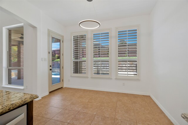 unfurnished dining area featuring light tile patterned flooring