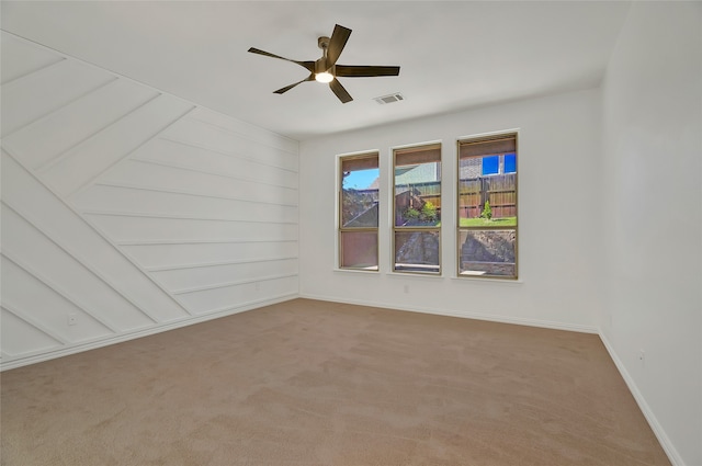 carpeted empty room featuring ceiling fan