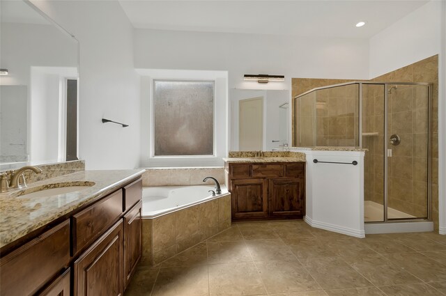 bathroom with independent shower and bath and vanity