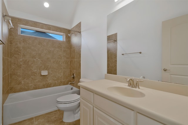 full bathroom with vanity, tiled shower / bath, tile patterned flooring, toilet, and lofted ceiling