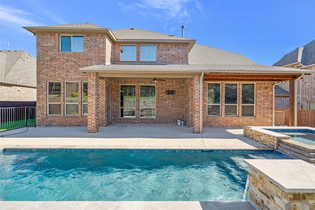 13647 Monstrell Rd, Frisco, TX 75035 - back of house with a patio area, brick siding, fence, roof with shingles, and a pool with connected hot tub
