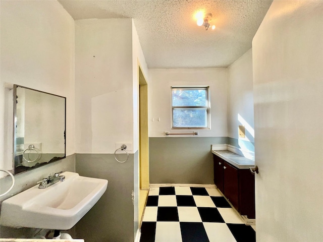 bathroom featuring sink and a textured ceiling