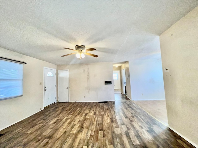 empty room featuring ceiling fan, wood-type flooring, and a textured ceiling