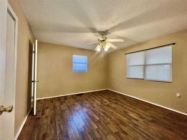 unfurnished bedroom featuring ceiling fan, dark hardwood / wood-style floors, and a textured ceiling