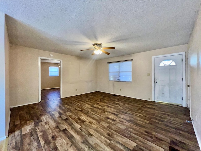 entrance foyer with dark hardwood / wood-style flooring, ceiling fan, and a textured ceiling