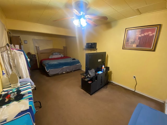 bedroom featuring ceiling fan, crown molding, and carpet