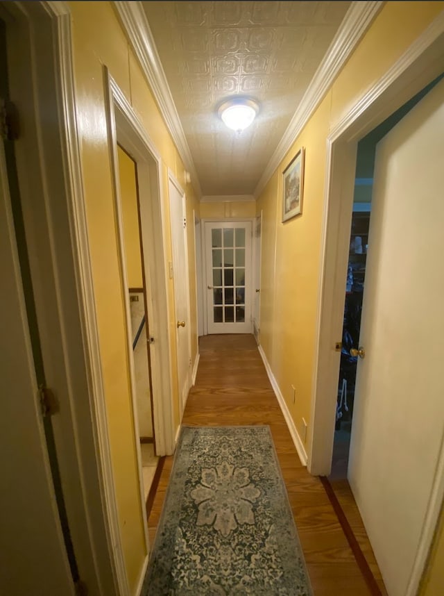 hall featuring light hardwood / wood-style flooring and ornamental molding