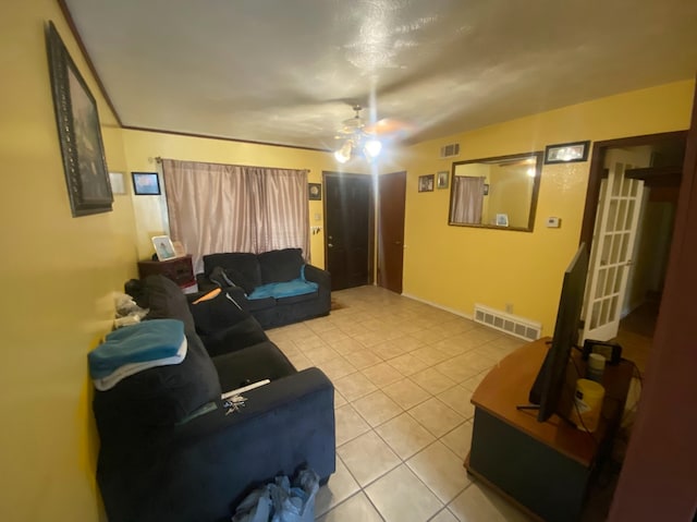 tiled living room with ceiling fan