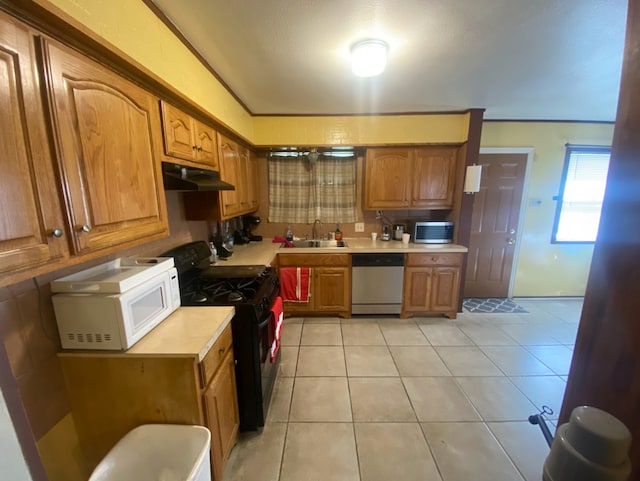 kitchen with light tile patterned flooring, sink, and appliances with stainless steel finishes