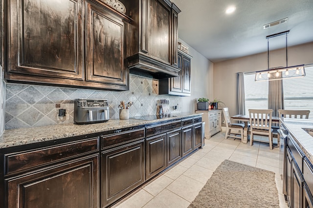 kitchen with black electric stovetop, decorative backsplash, hanging light fixtures, light tile patterned floors, and dark brown cabinets