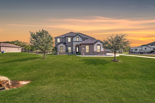 french country style house with a lawn