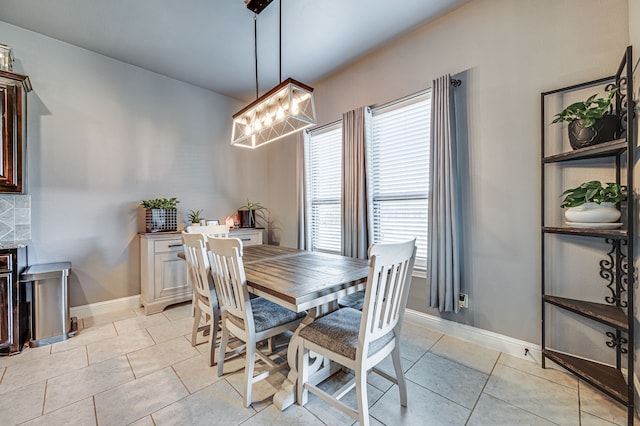 dining space with a chandelier and light tile patterned floors