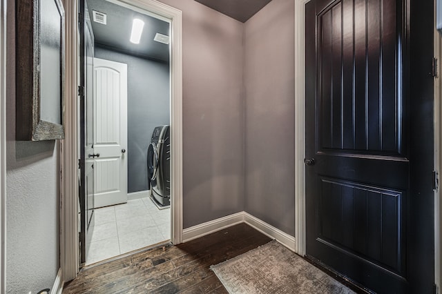 interior space with dark hardwood / wood-style flooring and independent washer and dryer