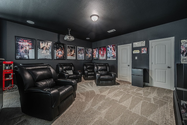 carpeted home theater room with a textured ceiling