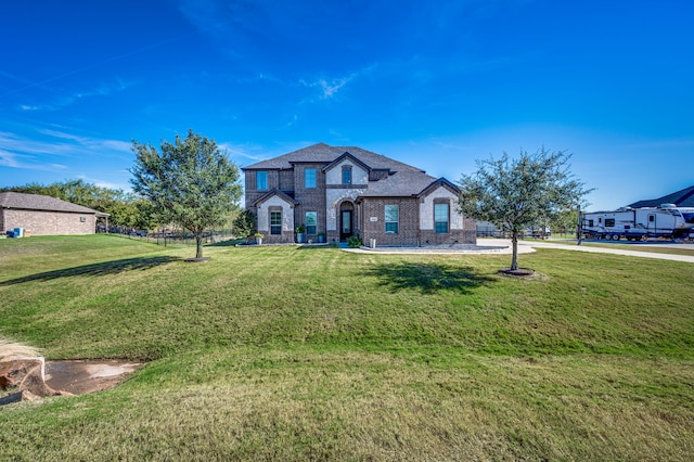 french provincial home featuring a front yard