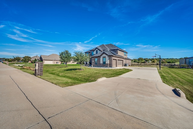 view of front of house featuring a garage and a front lawn