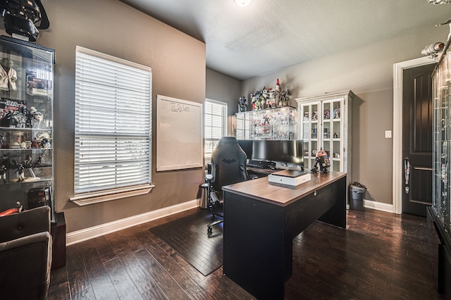 home office featuring a textured ceiling and dark hardwood / wood-style flooring