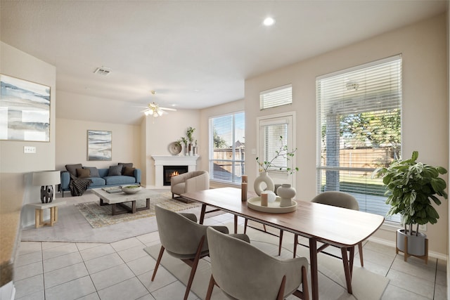 dining room featuring ceiling fan, a healthy amount of sunlight, and light tile patterned floors