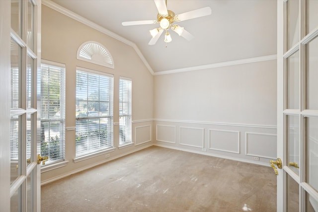 unfurnished room featuring ornamental molding, french doors, lofted ceiling, and light carpet