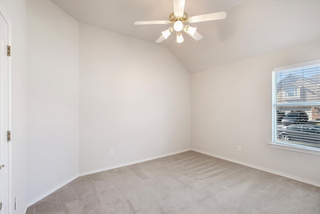 unfurnished room with vaulted ceiling, light carpet, and ceiling fan