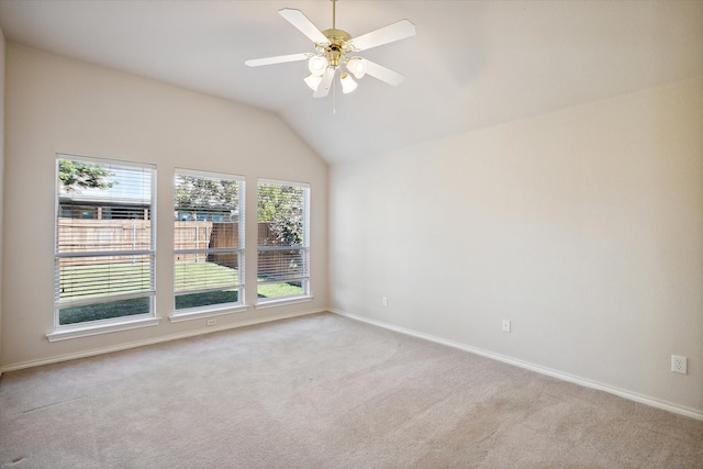 carpeted spare room with lofted ceiling and ceiling fan