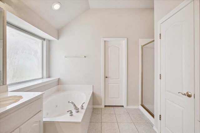 bathroom with independent shower and bath, vanity, tile patterned floors, and lofted ceiling