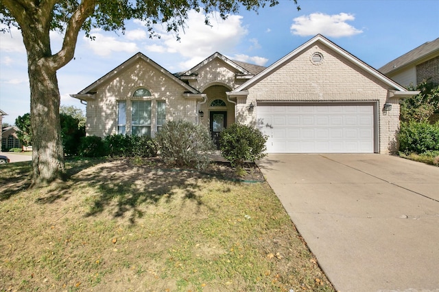 ranch-style house with a garage and a front yard