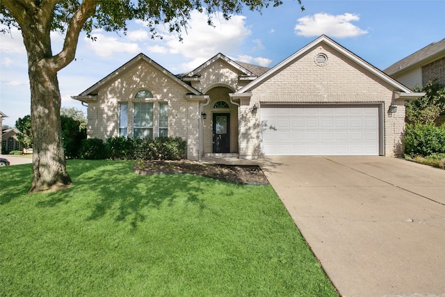 ranch-style home featuring a garage and a front lawn