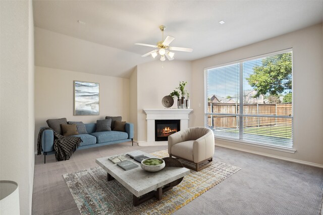 carpeted living room with lofted ceiling and ceiling fan