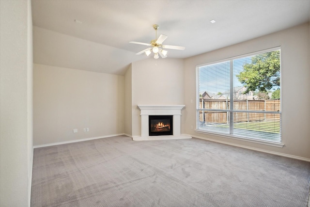 4301 Stonecrest Ct, Fort Worth, TX 76244 - unfurnished living room with a ceiling fan, a warm lit fireplace, carpet flooring, and baseboards