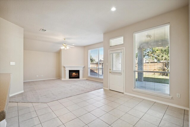 unfurnished living room with ceiling fan and light carpet