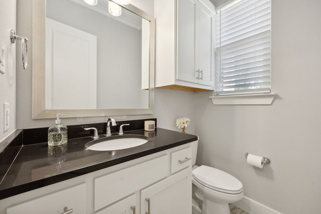 bathroom with toilet and vanity