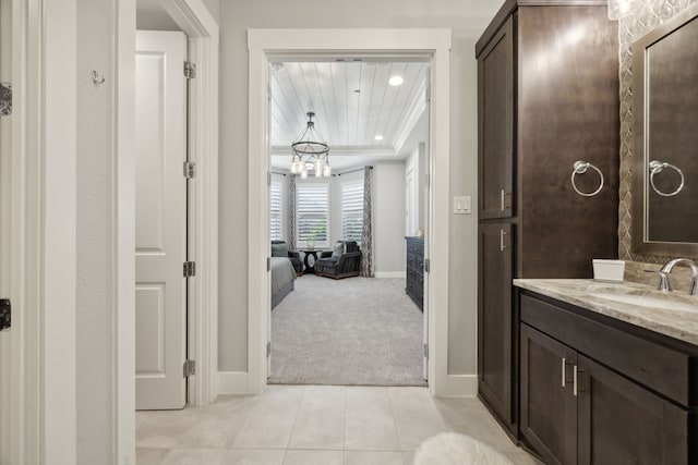 bathroom featuring vanity, a chandelier, and tile patterned floors