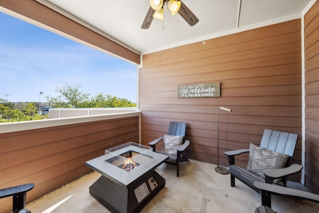 balcony featuring a fire pit and ceiling fan