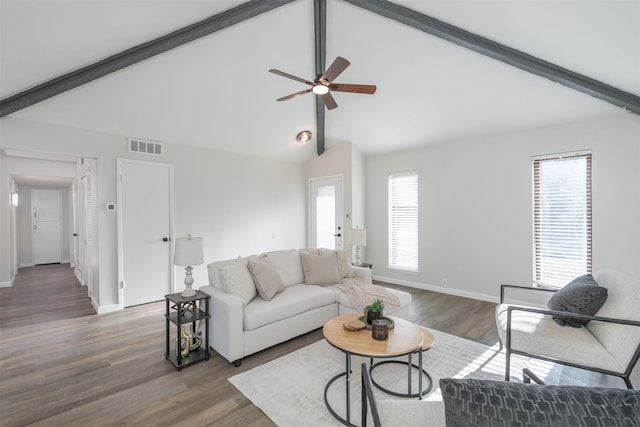 living room featuring plenty of natural light, lofted ceiling with beams, and dark hardwood / wood-style flooring