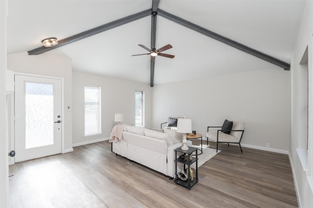 living room featuring vaulted ceiling with beams, ceiling fan, and hardwood / wood-style floors